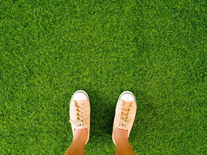 aerial shot of someone standing on artificial grass